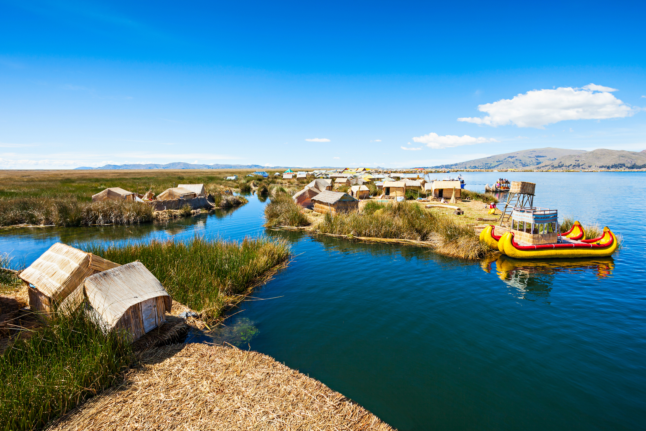 Boats and houses by Lake Titicaca on the Peruvian side