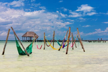 Colourful hammocks in the sea in Mexico