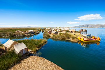 Boats and houses by Lake Titicaca on the Peruvian side