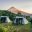 Tents set up on a grassy hill on a trek