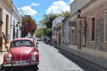 Red car parked on a road in Uruguay