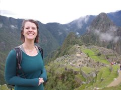 Woman smiling in front of Machu Picchu in Peru