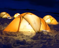 Lit up tents in the snow in Antarctica