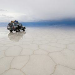 jeep in the salt lake salar de uyuni, bolivia